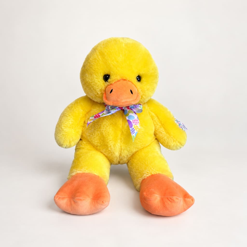 Yellow plush duck with orange beak and feet, wearing a patterned ribbon