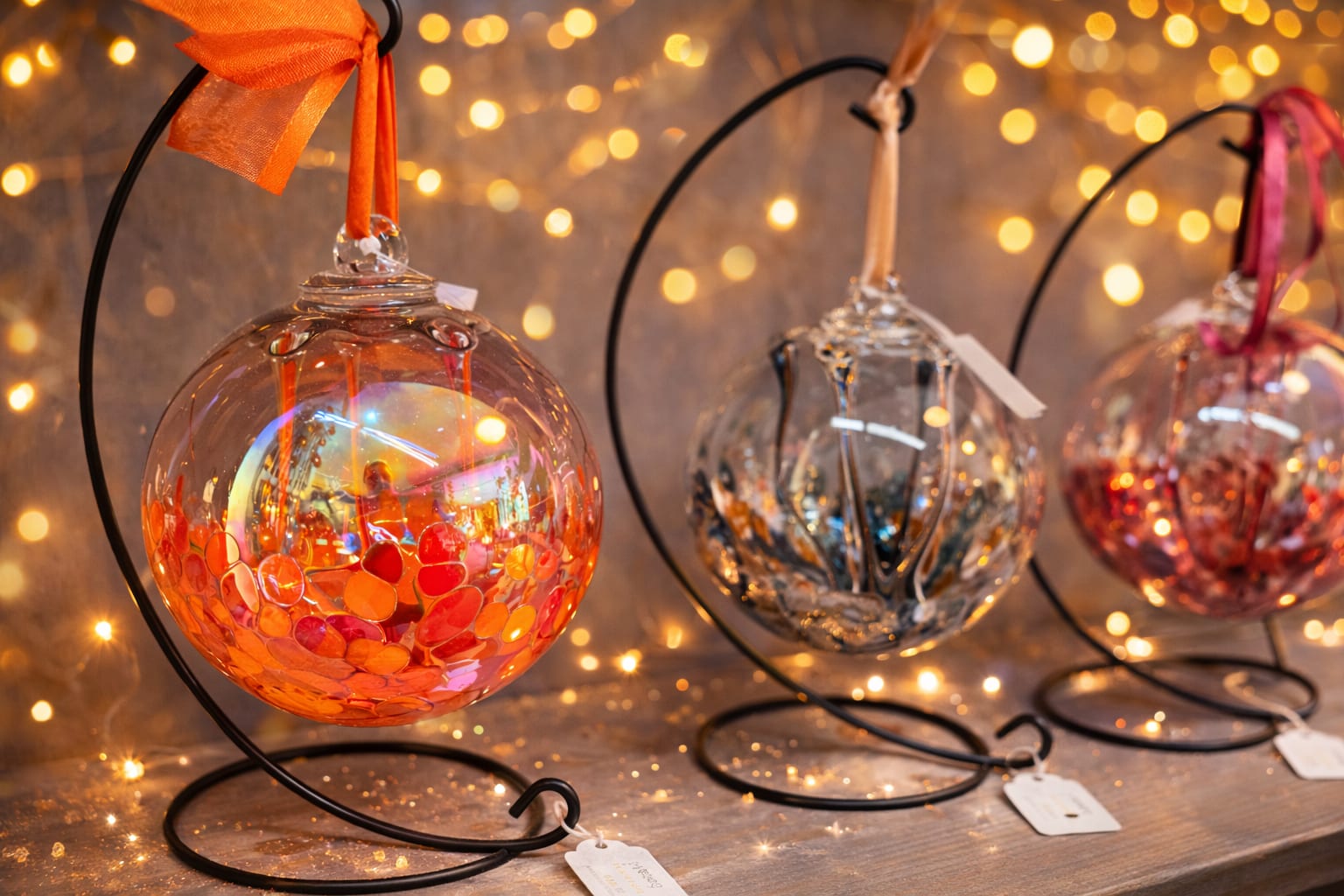 Glass Orb on a Stand - 6 inch - Add a touch of beauty and meaning to any space with these stunning handcrafted glass ornaments. Each piece is uniquely designed with rich colors, delicate patterns, and a luminous finish that catches the light beautifully. Suspended on an elegant metal stand, these ornaments are ready to display and make an eye-catching addition to any home or office. Perfect as a thoughtful gift, these ornaments are especially meaningful for memorials and funerals—offering a lasting symbol of love, remembrance, and comfort. Their timeless design makes them suitable for celebrating special moments or honoring cherished memories.  Features: Hand-blown glass with one-of-a-kind patterns Includes decorative metal display stand Ready to gift and easy to display Ideal for sympathy gifts, memorials, or special occasions A beautiful keepsake that brings warmth, reflection, and elegance wherever it is placed.