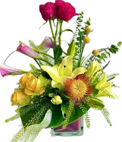 Mixed bouquet in a clear glass vase with lilies, roses, and pink blooms
