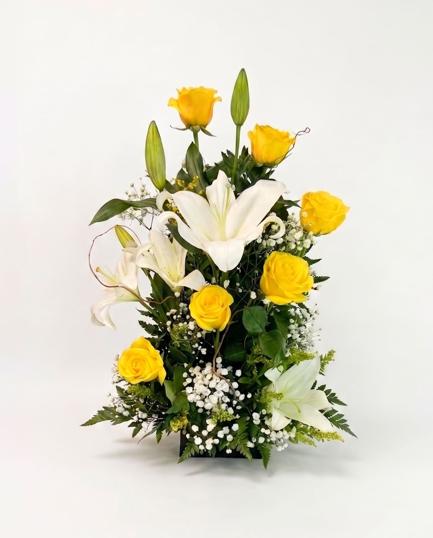 Yellow Roses and Lilies Bouquet - 6 Yellow Roses delicately accented with white Lilies and Babies Breath make this bouquet perfect for just about any occasion.