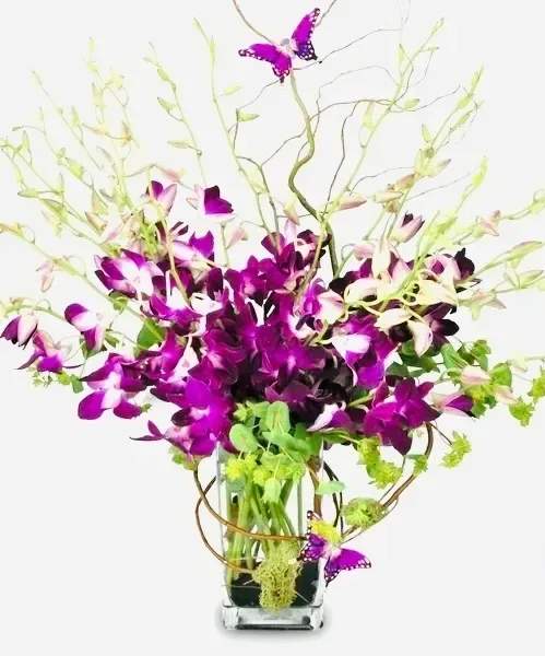 Purple orchids in a glass vase with butterfly accents