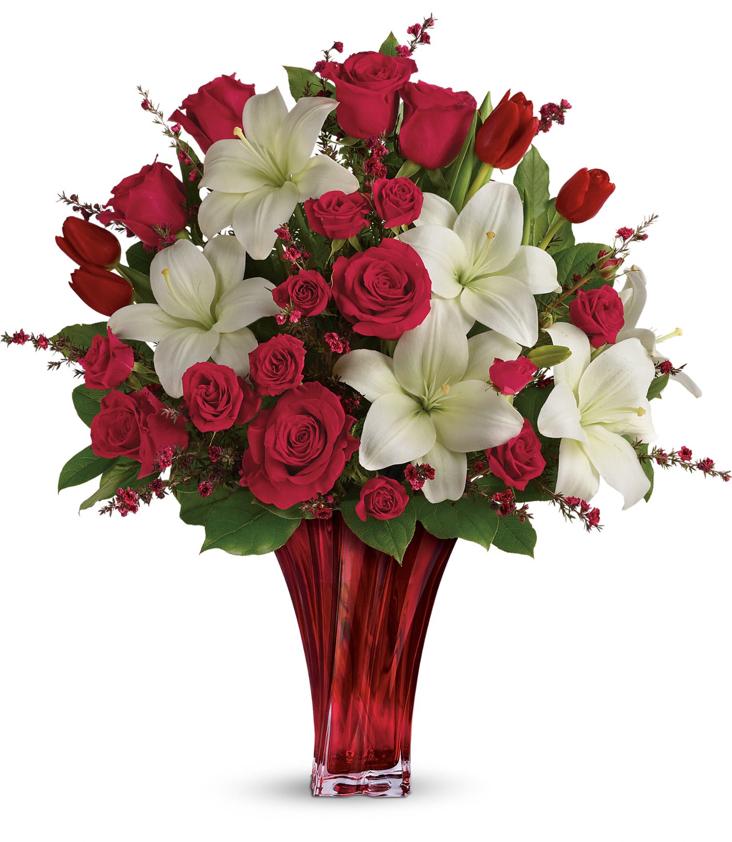 Love's Passion Bouquet by Teleflora PM - Classic romance is this radiant bouquet of red roses, crimson tulips and pure white lilies, hand-delivered on Valentine's Day or any day in an exquisite blown glass vase. With its radiant red hue and unique twisting shape, it's sure to take their breath away! 
