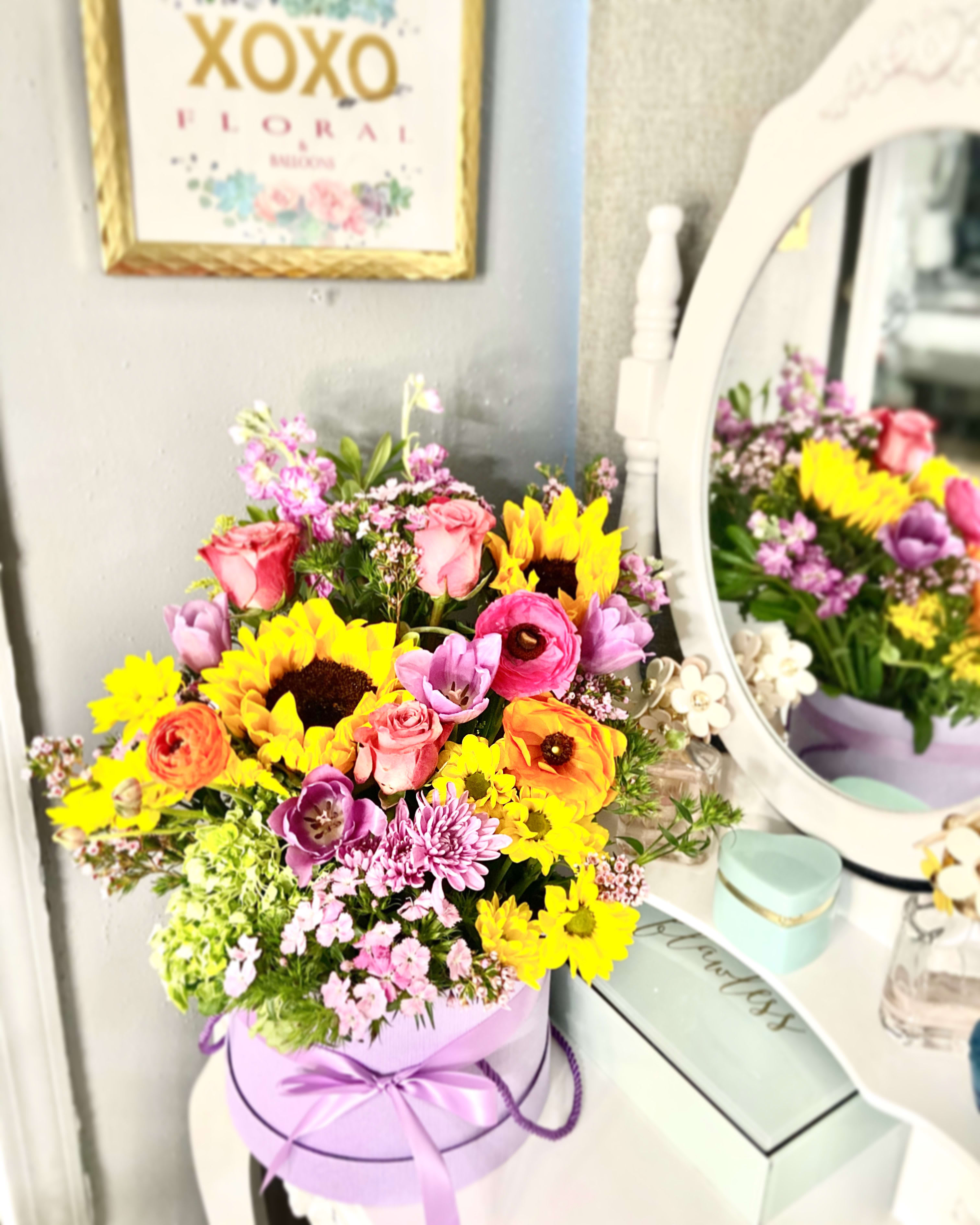 Colorful mixed bouquet in a lavender hat box with a ribbon