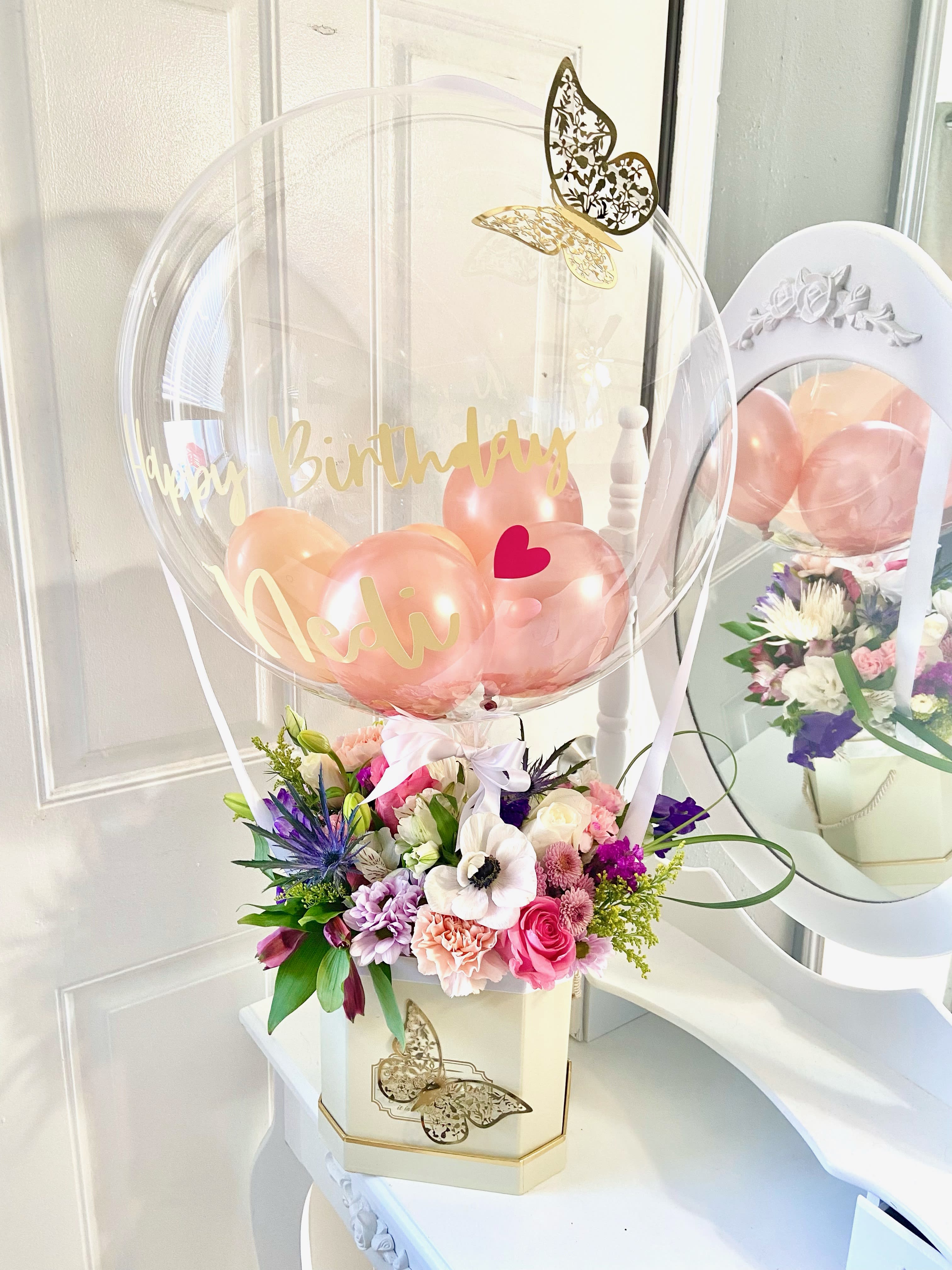 Birthday balloon arrangement with flowers in a decorative box