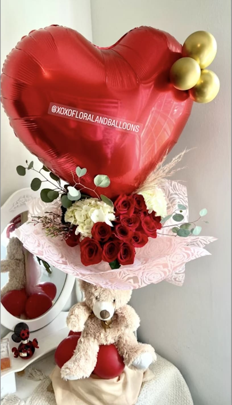 Red heart balloon with roses and a teddy bear gift arrangement