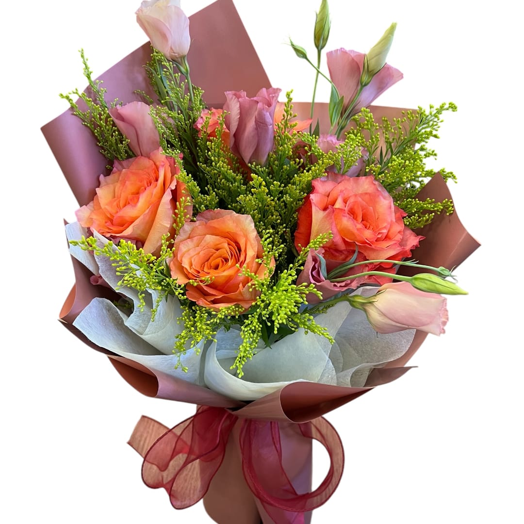 Bouquet of orange roses and pink lisianthus wrapped in paper