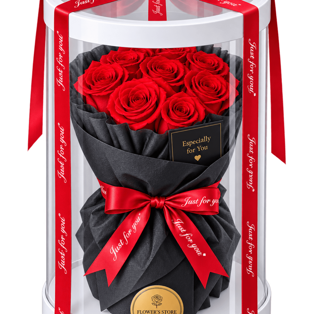 Red roses in a black wrapped bouquet inside a clear gift box with red ribbons.