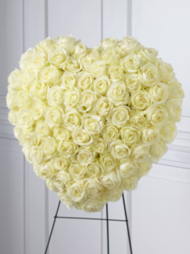 Elegant Remembrance - 77 Stems of white roses are artfully arranged in the shape of a heart and presented on a wire easel, creating a simply beautiful tribute for their final farewell service. Approximate size: 24’h x 22’w