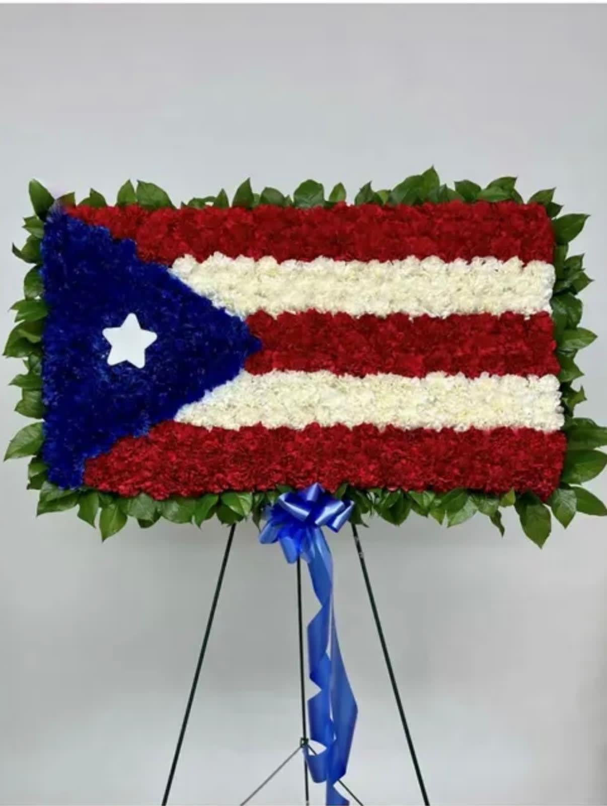Floral standing display arranged like the Puerto Rico flag on an easel