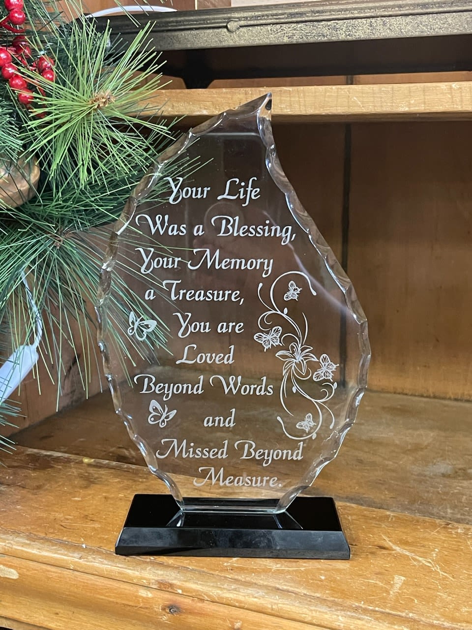 Clear memorial plaque on a black base with engraved sympathy message