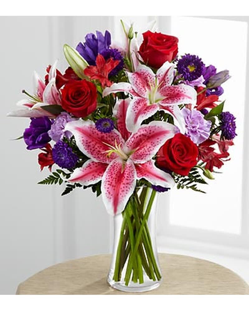 Stunning Beauty - The Stunning Beauty™ Bouquet by FTD® is an absolutely lovely way to send your love and affection across the miles. Fragrant Stargazer lilies stretch their star-like petals across a bed of rich red roses, lavender carnations, red Peruvian lilies, purple double lisianthus, purple matsumoto asters and lush greens. Presented in a classic clear glass vase, this elegant bouquet is an incredible way to convey your sweetest sentiments.