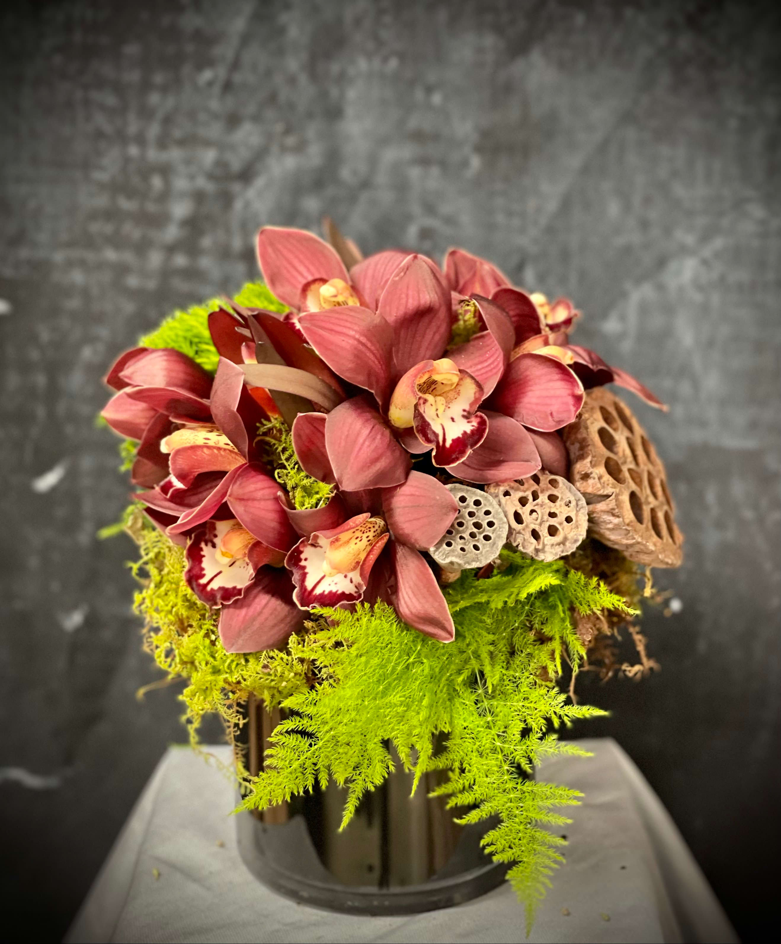 Vienna Lotus Love - Cymbidium, green dianthus, lotus and greenery.