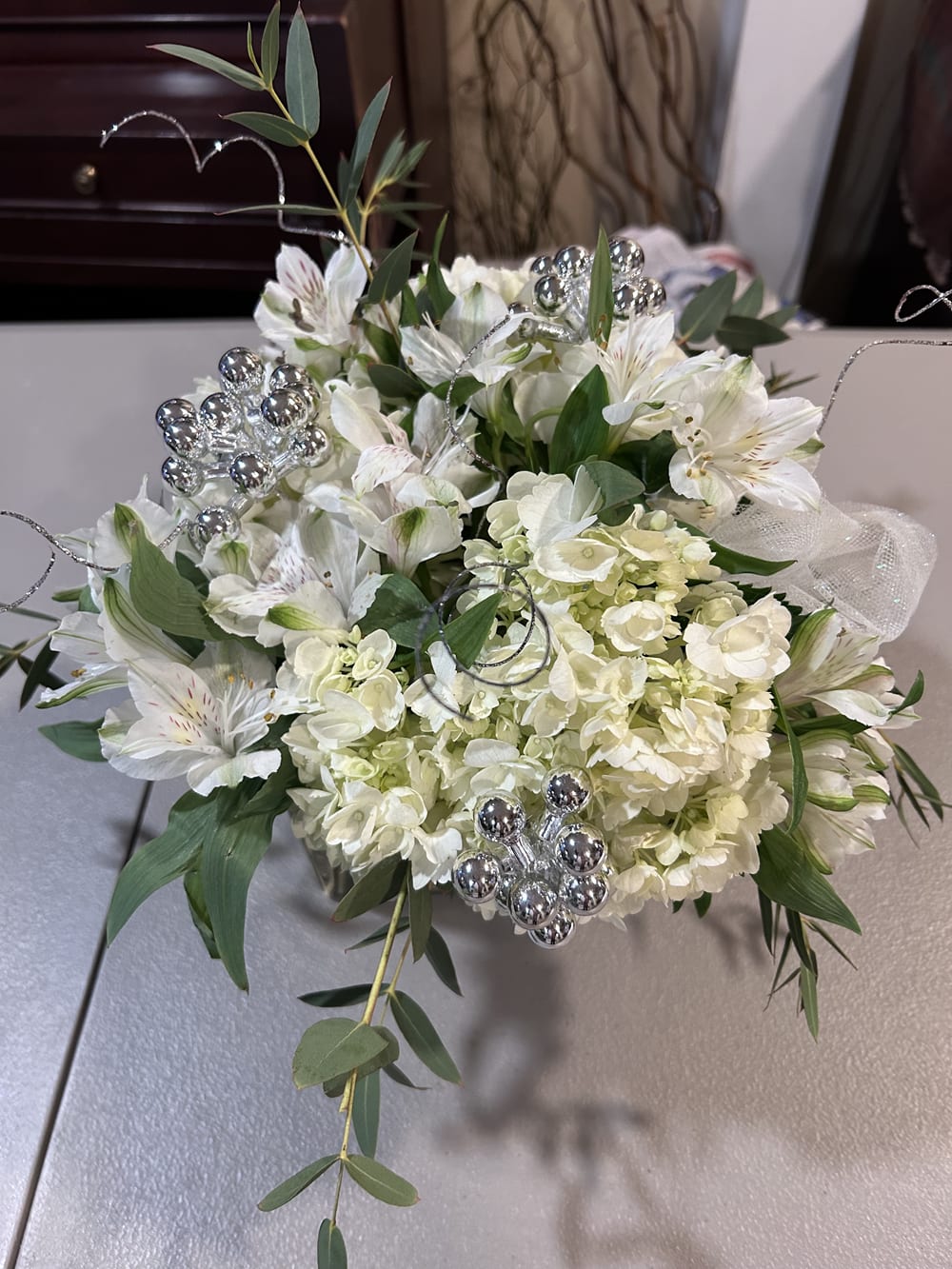 White floral bouquet with silver decorative accents