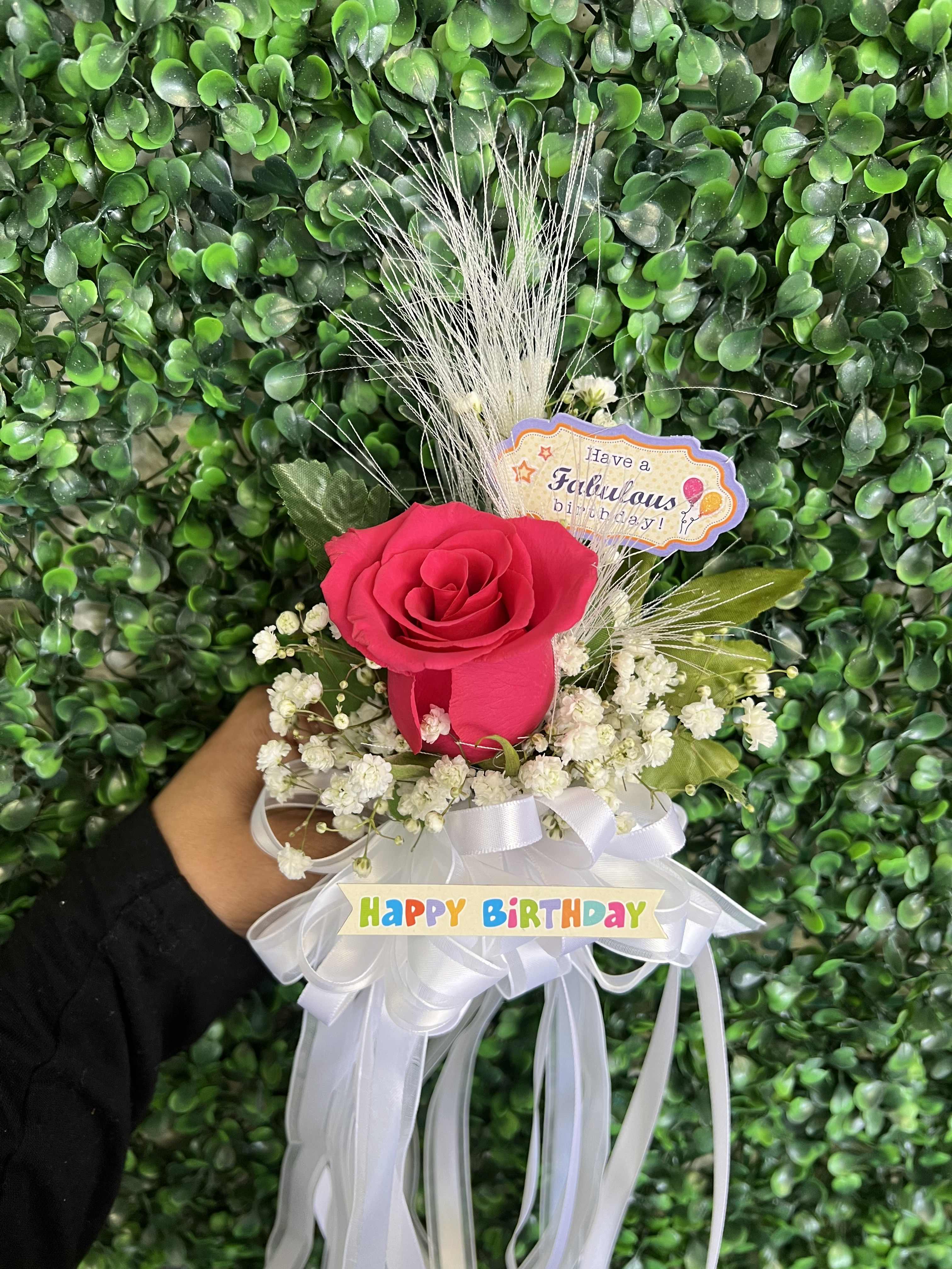 Pink rose bouquet with white baby's breath and birthday ribbons