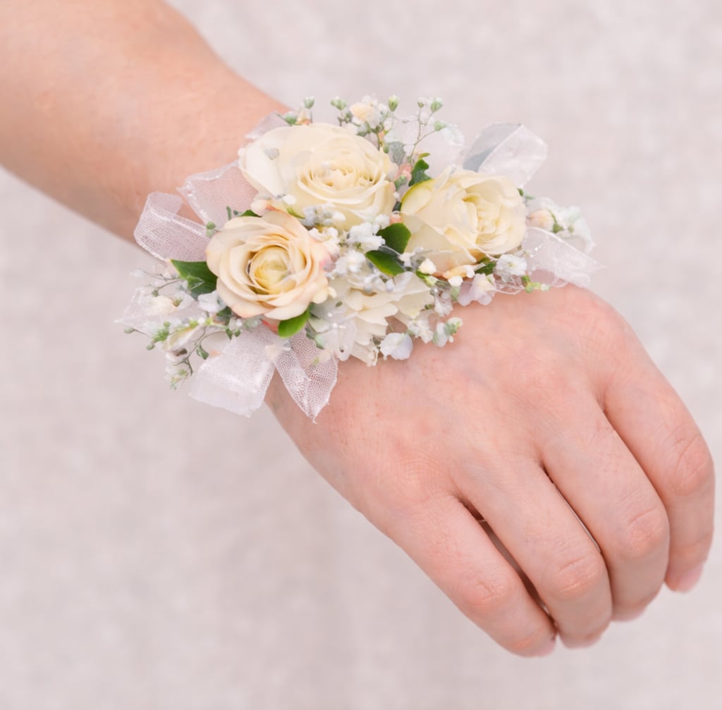 Wristlet Corsage - **Tell Us Your Color Preference In The Special Instructions** Elegant and effortlessly wearable, our wristlet corsages are designed to add a beautiful floral touch without the need for pinning. Each piece is handcrafted with fresh, high-quality blooms and accented with delicate greenery, all securely arranged on a comfortable, adjustable band. Perfect for proms, weddings, and special events, our wristlet corsages are styled to coordinate seamlessly with your florals while providing a modern, graceful look.