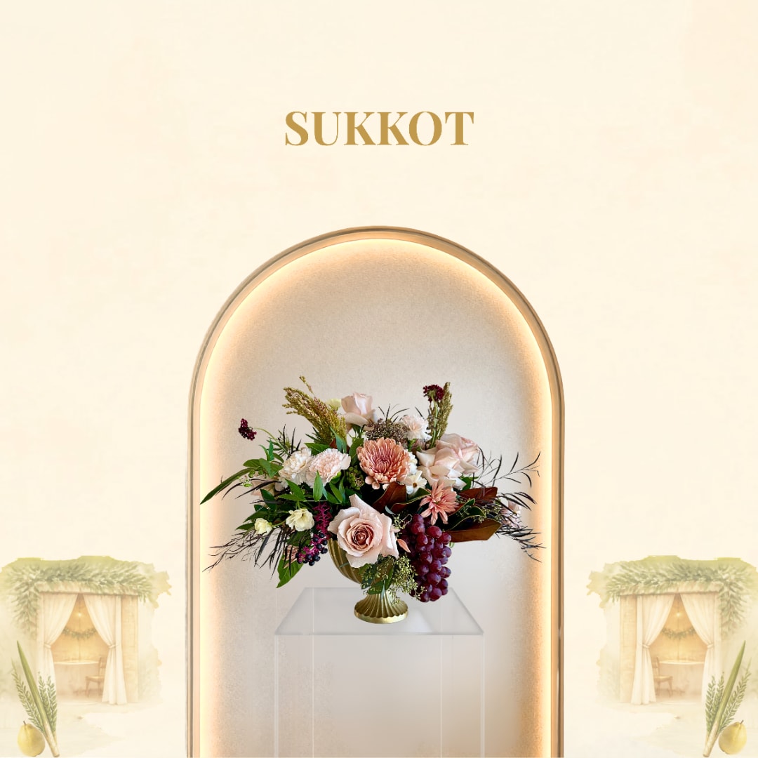 Mixed floral arrangement in a gold vase with pale pink and burgundy blooms