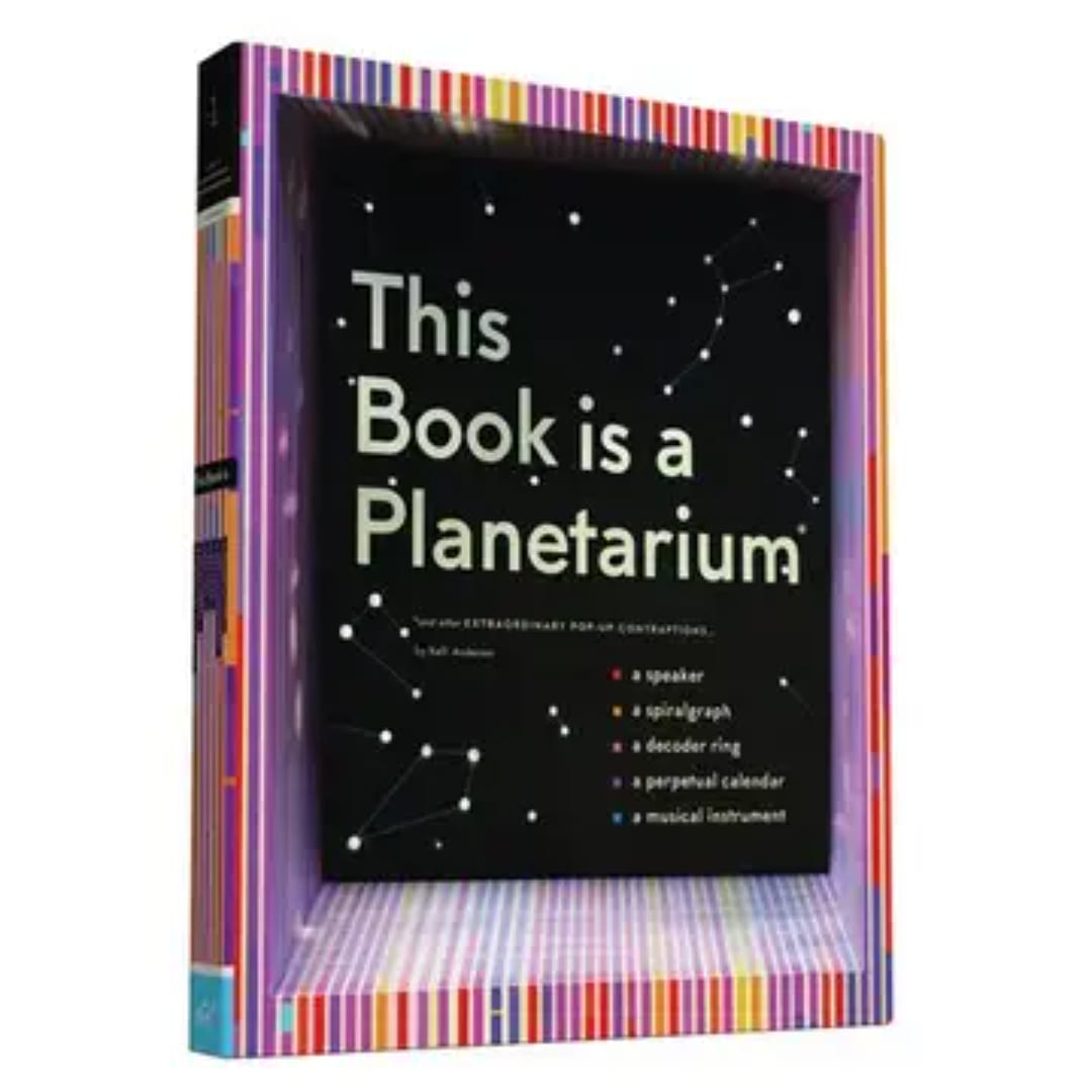 A boxed book gift set with a black cover and colorful striped border