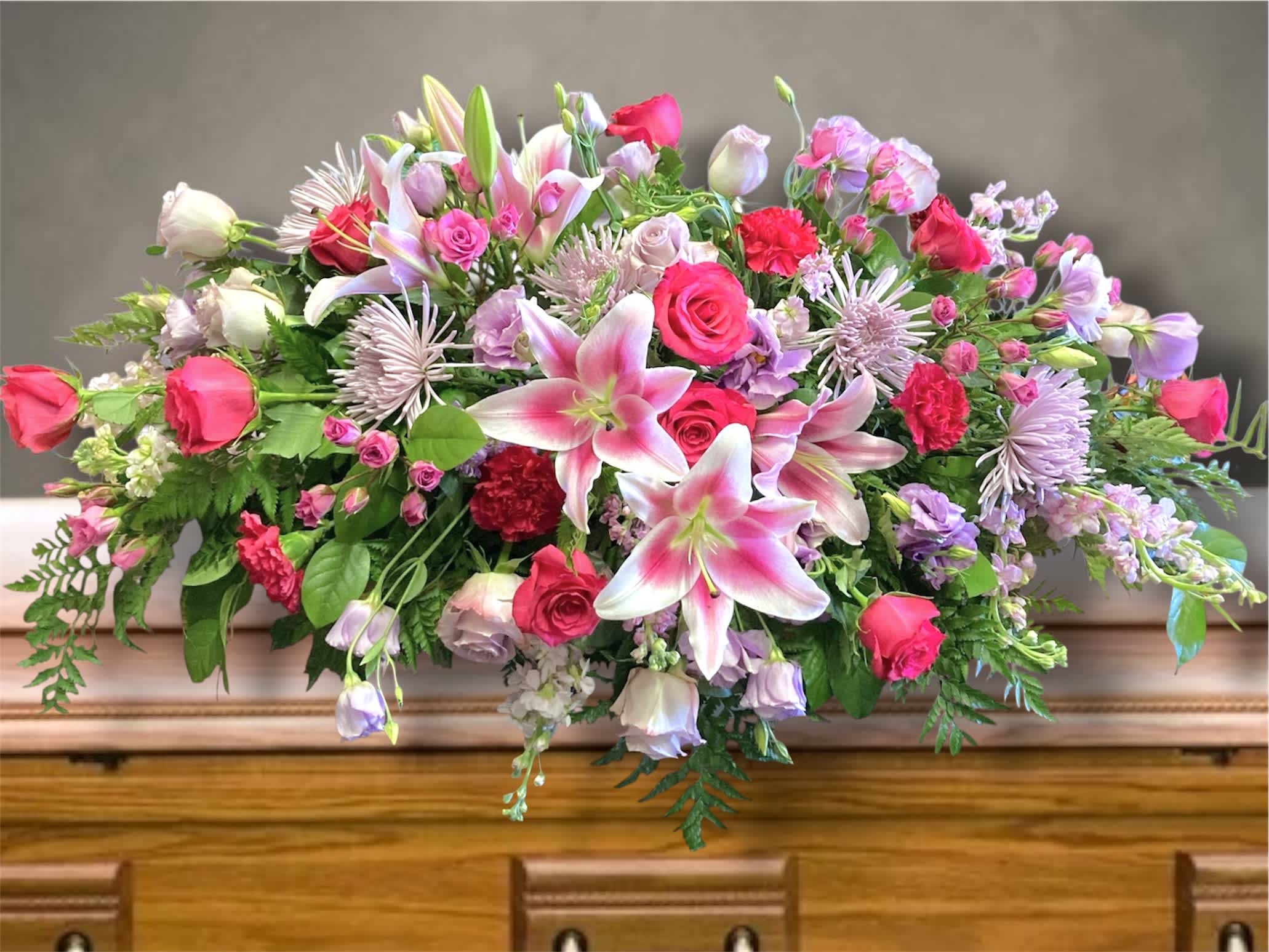 Large pink and lavender floral arrangement with lilies and roses