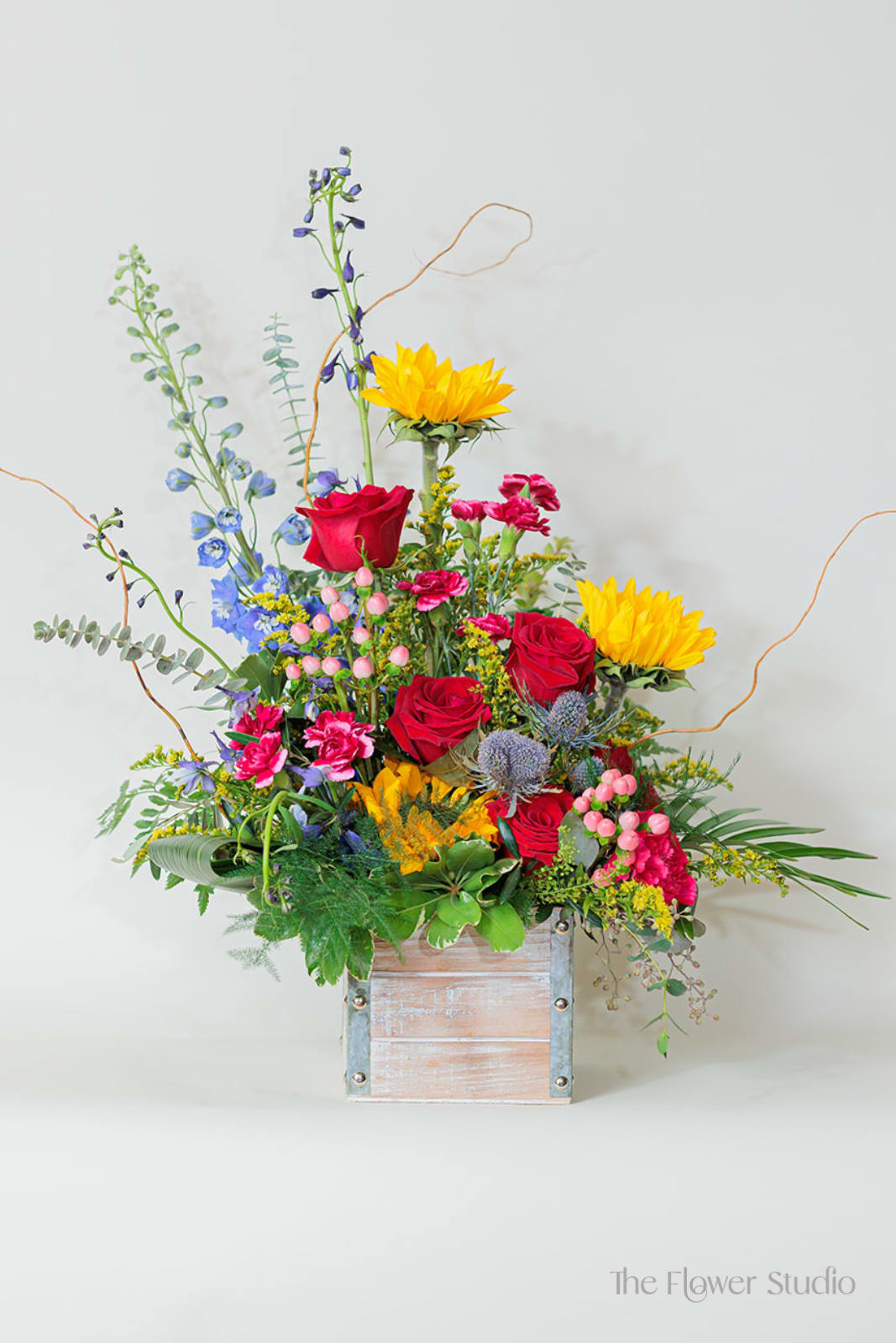 Colorful mixed flower arrangement in a wooden box