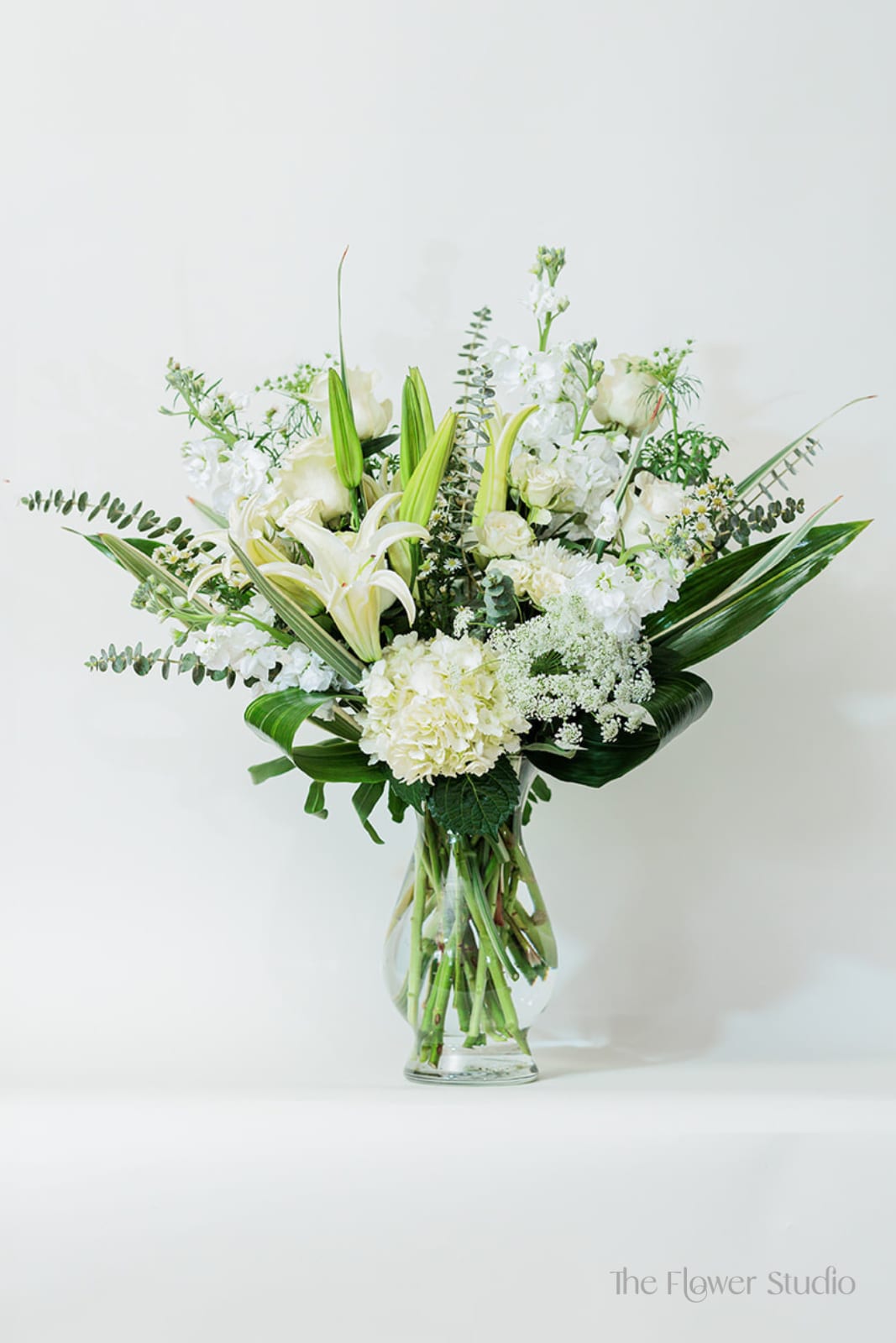 White floral arrangement in a clear glass vase