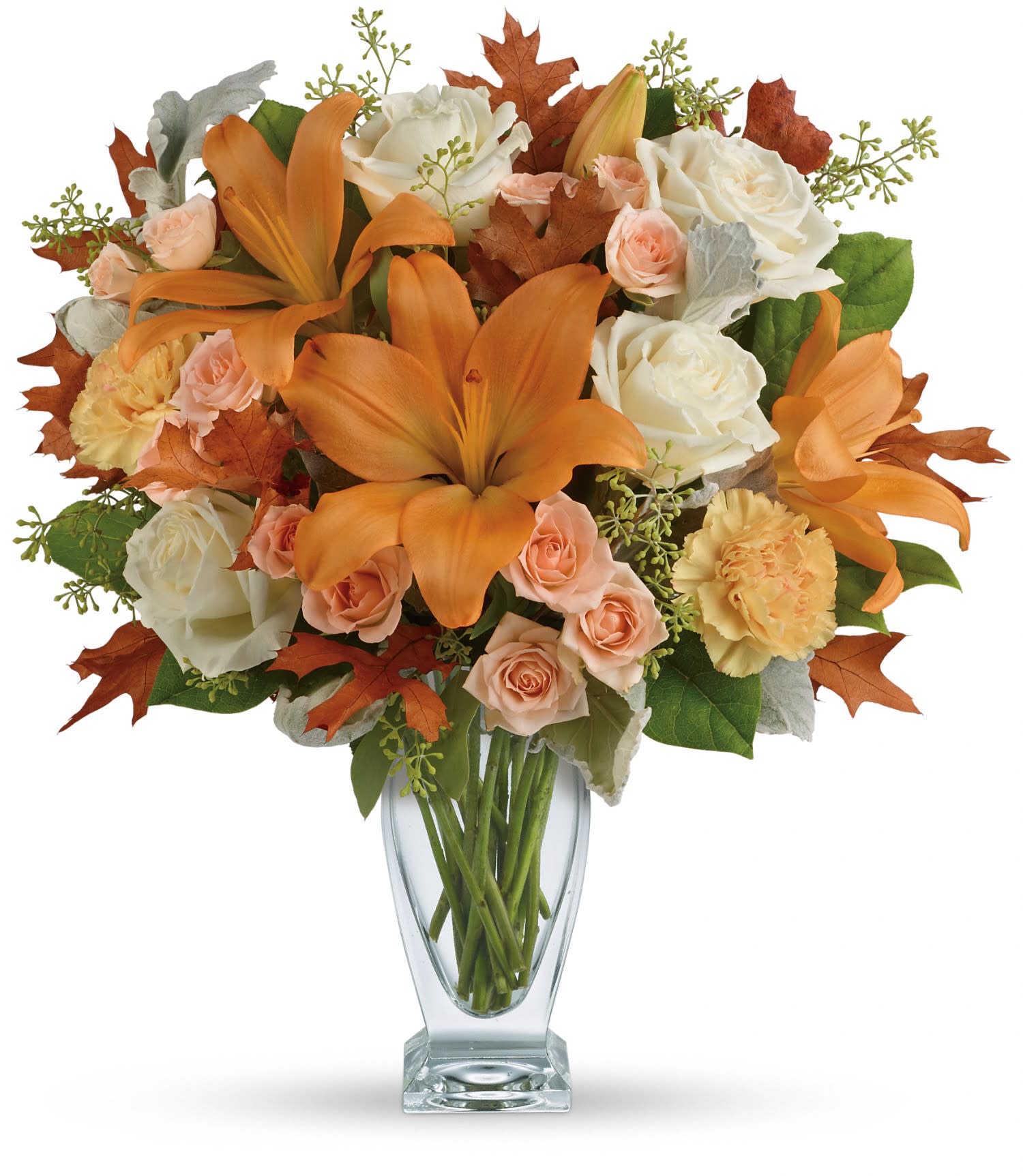 Teleflora's Seasonal Sophistication Bouquet - This beautiful arrangement features white and peach roses, peach asiatic lilies and peach carnations and is finished with dusty miller, seeded eucalyptus, brown oak leaves and lemon leaf. Delivered in a Couture vase. Approximately 16 1/4" W x 18" H
