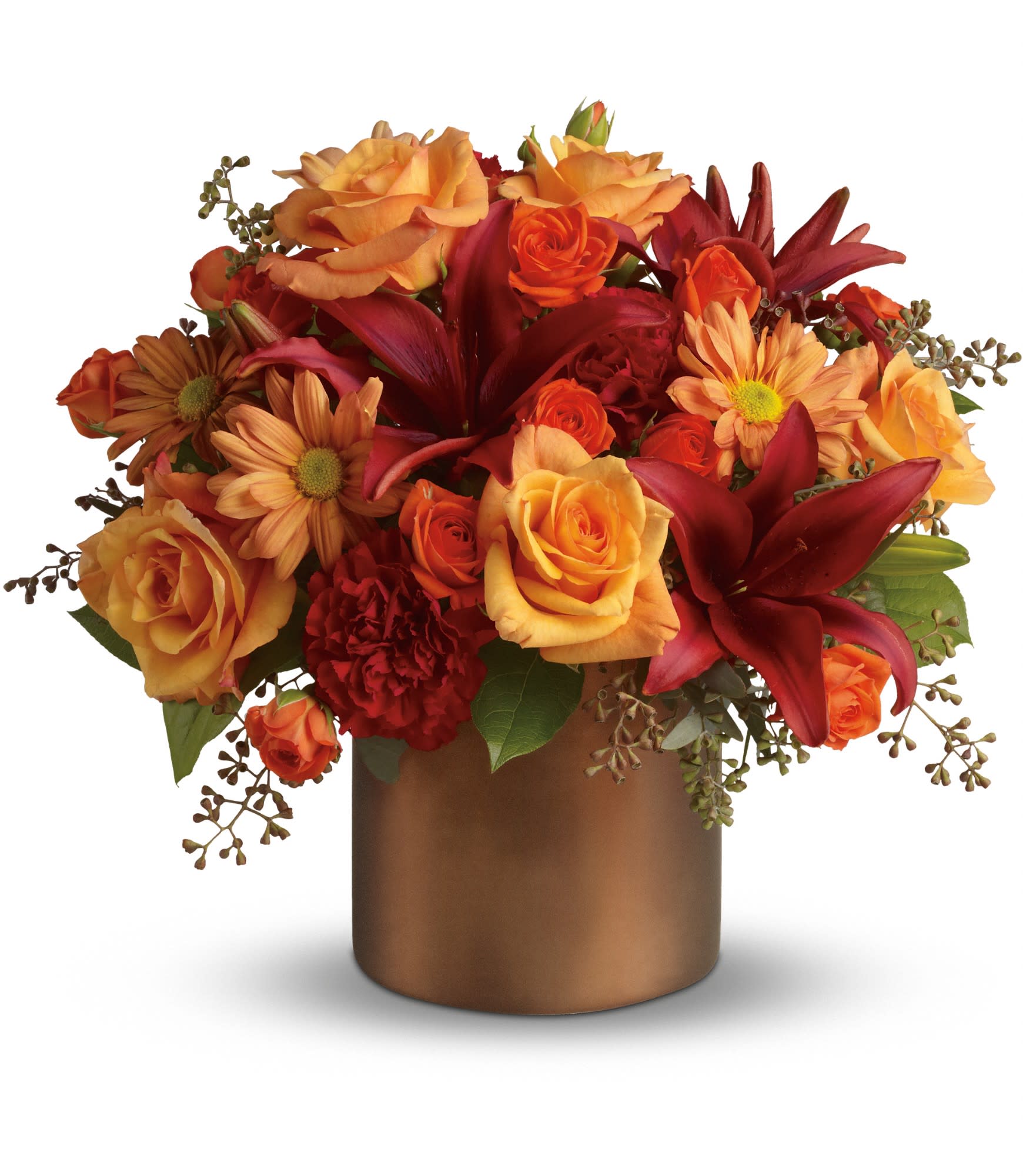 Teleflora's Amazing Autumn - Gorgeous orange roses, spray roses and chrysanthemums, dazzling burgundy asiatic lilies, red carnations, and eucalyptus and even preserved yellow oak leaves are splendidly arranged in a satin vase. It's amazing, all right! Approximately 17" W x 18" H. T166-1A 