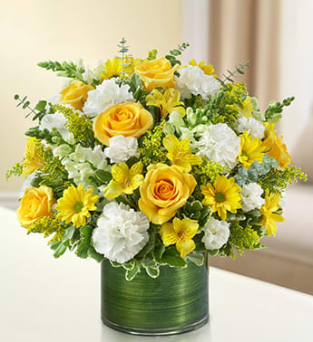  Yellow and White -    A vivid yellow and white bouquet of roses, snapdragons, alstroemeria, carnations and more is arranged in a classic cylinder vaseyellow and white arrangement of roses, snapdragons, alstroemeria, carnations, daisy poms, mini carnations and solidago, gathered with variegated pittosporum and spiral eucalyptus Hand-designed by our expert florists in a stylish clear glass cylinder vase wrapped with a Ti leaf ribbon; vase measures 6"H Appropriate for the Large arrangement measures approximately 16"H x 17"L Medium arrangement measures approximately 15"H x 16"L Small arrangement measures approximately 14"H X 15"L Our florists hand-design each arrangement, so colors, varieties, and vase may vary due to local availability