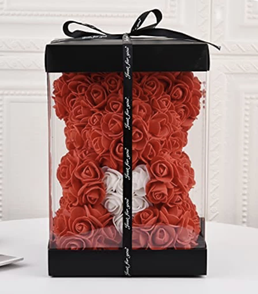Red rose teddy bear in a clear gift box with a black ribbon