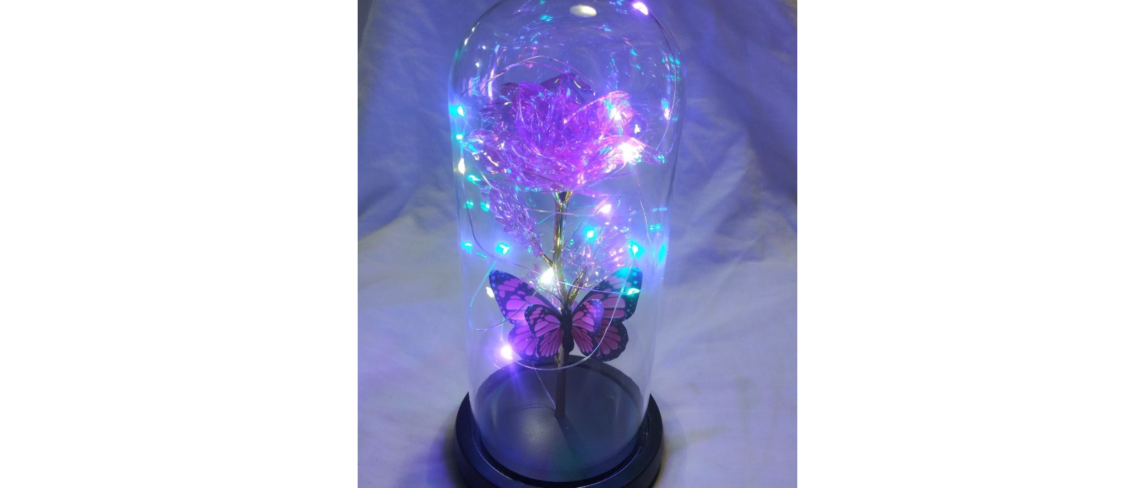 Purple light-up rose in a clear dome with a butterfly decoration