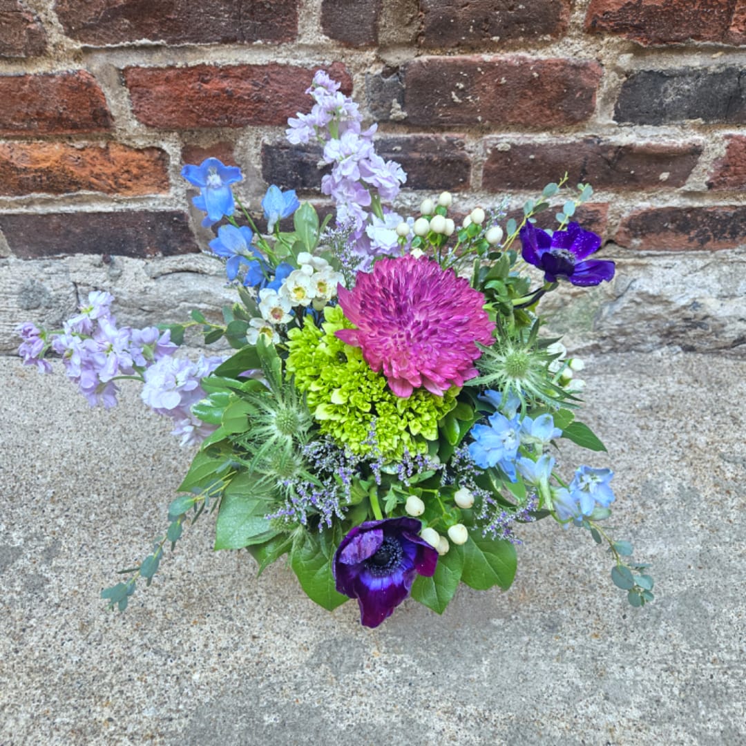 Colorful mixed bouquet with blue, purple, pink, and green flowers