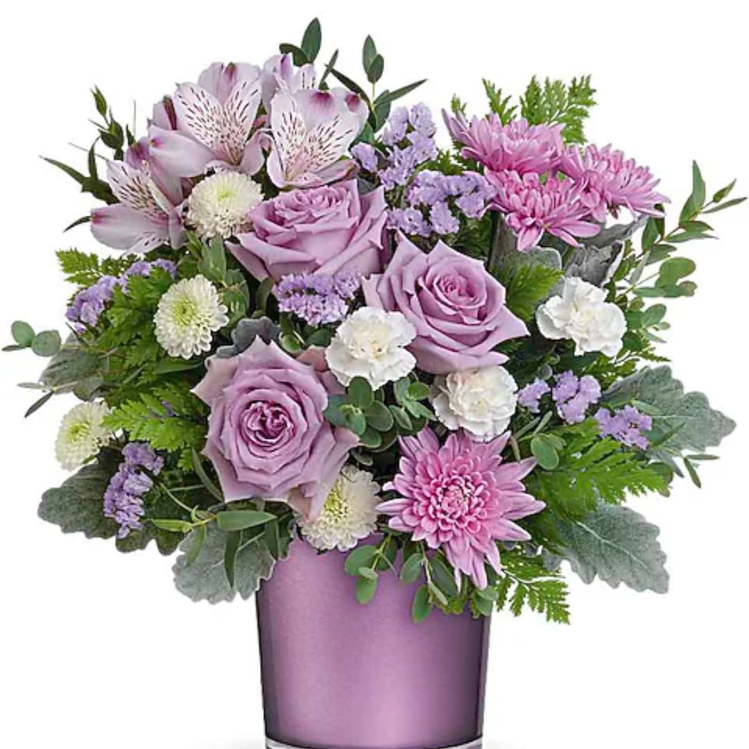 Enchanted Moments Bouquet - Experience the enchantment of blooms delivered! Purple roses in a polished gem vase transform any day into something truly special. Experience elegance with a bouquet featuring lavender roses, alstroemeria, white carnations, white button chrysanthemums, lavender cushion chrysanthemums, lavender sinuata statice, dusty miller, leatherleaf fern, and parvifolia eucalyptus, all beautifully arranged in the Purple Amethyst Polished Gem Cylinder.