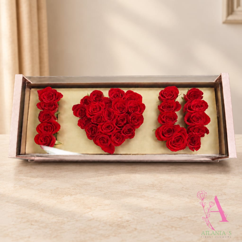 Red roses arranged to spell "I ♥ U" in a rectangular box