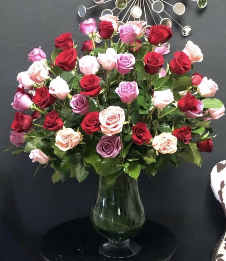 Mixed roses in a clear glass vase