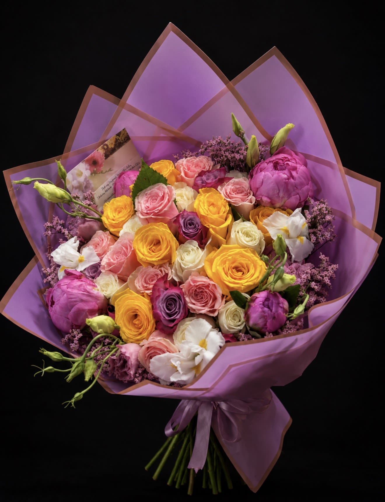 Pastel Love Rose &amp; Peony Wrap (No Vase) - A lush, hand-tied bouquet of pastel roses and peonies designed to make someone feel truly seen-the perfect "just because" surprise or a gentle congratulation for a new baby. This pastel love flower arrangement reads bright and romantic at a glance: rounded clusters of pink, yellow, cream, and lavender roses are softened by white lisianthus and small purple filler blooms, all wrapped in coordinating purple paper and finished with a satin ribbon and a greeting card.  The arrangement is dense and full-bodied, with a premium, gift-ready silhouette that feels both celebratory and intimate. Textures contrast pleasantly-the velvety rose petals and the airy lisianthus create depth while the small purple fillers add playful sparkle. Delivered without a vase, the bouquet arrives ready to display in any container the recipient chooses or to be presented as a handheld, moment-making gift.  Perfect for saying thank you, welcoming a new baby, or brightening Father's Day with an unexpected soft palette, this bouquet sends a message of warmth and thoughtful attention. Include personal words on the enclosed greeting card and follow simple care: recut stems and place in fresh water to extend the life of these delicate blooms.