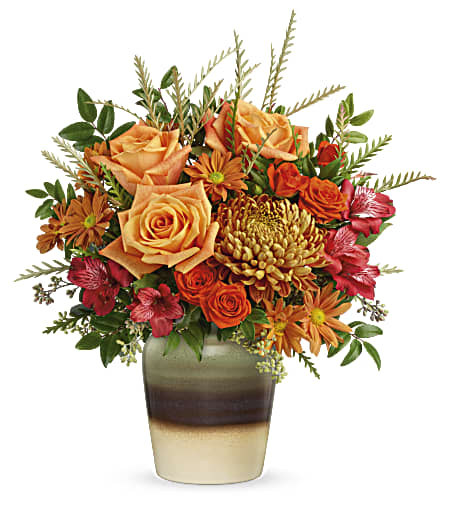 Teleflora's Autumn Gifts Bouquet - Full of fall elegance, this radiant autumnal arrangement arrives in a stunning stoneware vase with reactive glaze and distressed details, making it a favorite year-round accent piece or kitchen crock!