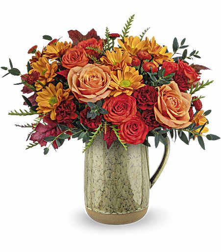 Teleflora's Majestic Meadow Bouquet - Embrace the charm of autumn's majestic meadow with this heartfelt rose bouquet, presented in a stunning stoneware pitcher with a captivating reactive glaze. This versatile piece is not only a beautiful centerpiece but also food-safe, making it ideal for decorating your table on Thanksgiving or any memorable occasion.
