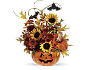 Teleflora's Trick &amp; Treat Pumpkin - Happy jack-o-lanterns, earthy tones and autumn colors swirl, bringing back childhood memories of Halloween and the autumn season.