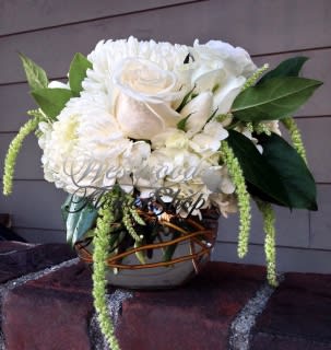 White rose and chrysanthemum arrangement in a woven vase