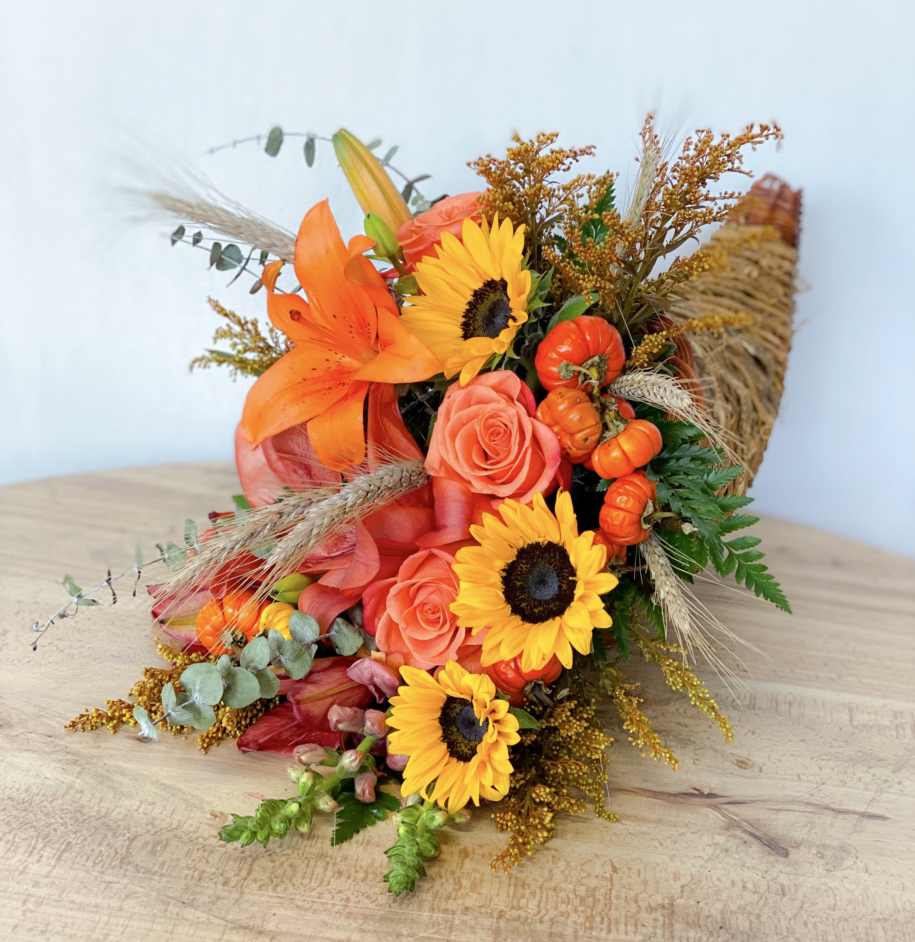 Orange and yellow bouquet with roses, sunflowers, and lilies