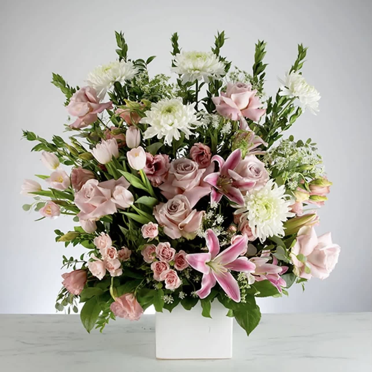 Harmony Bouquet - Keep the harmony of your relationship alive by sending this lovely pink and white bouquet uniquely designed with lilies and roses arranged in a keepsake ceramic cube vase. Perfect for all occasions! Best for home or office! Guaranteed to “WOW”!  Approximately 22” H x 16” W