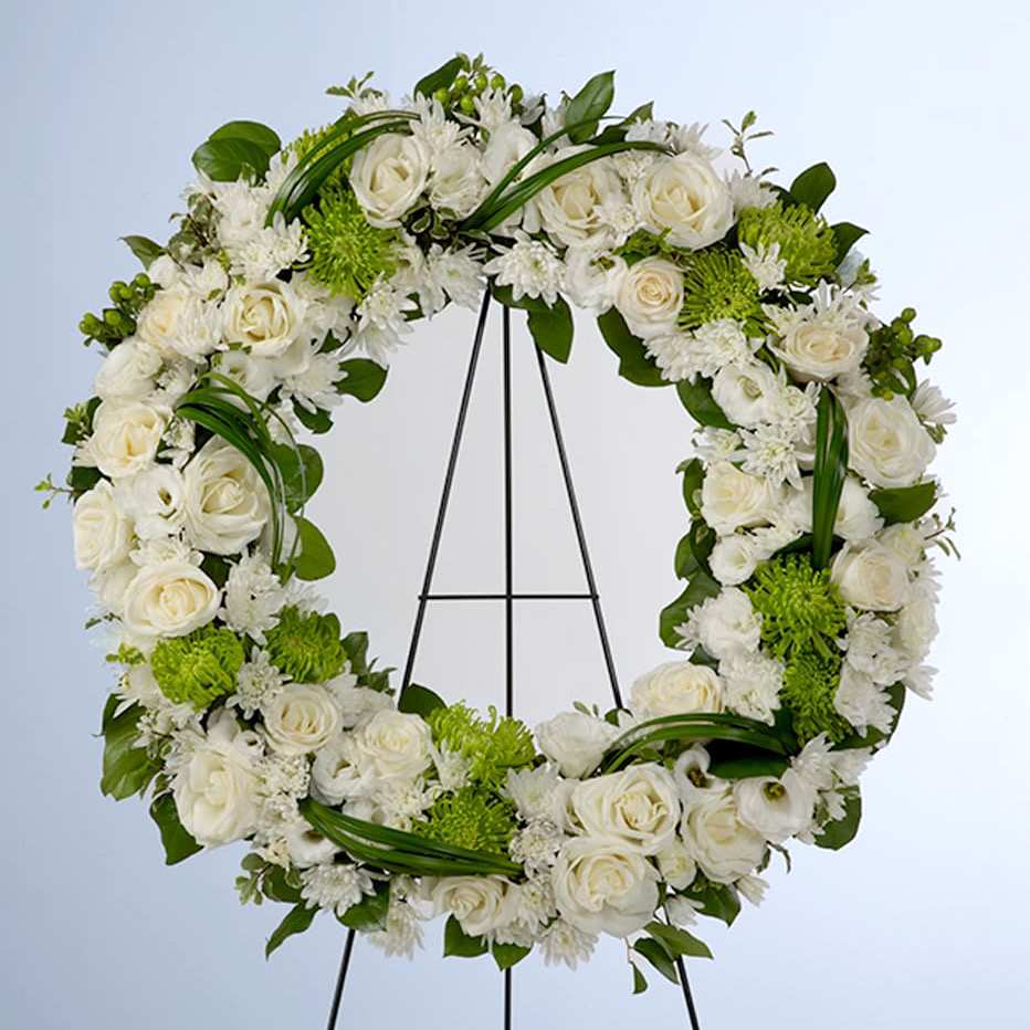 Lasting Serenity - A beautiful white and green tribute wreath that calms, this easel arrangement celebrates a full life and a peaceful passing.   Approximately 22” D