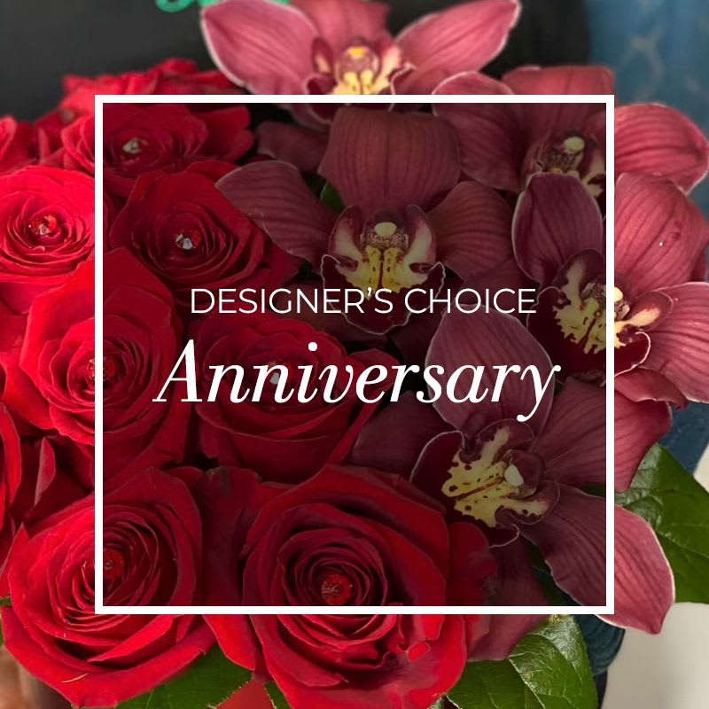 Red roses and burgundy orchids in a bouquet