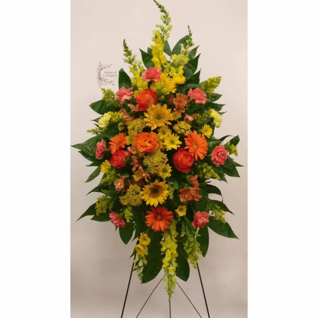 Tall standing floral spray with yellow, orange, and pink flowers