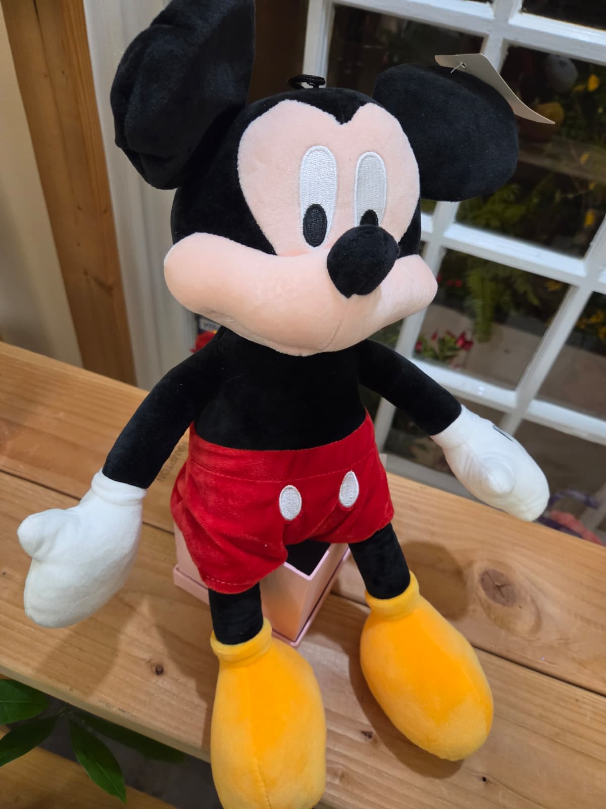 Plush Mickey Mouse toy in red shorts and yellow shoes