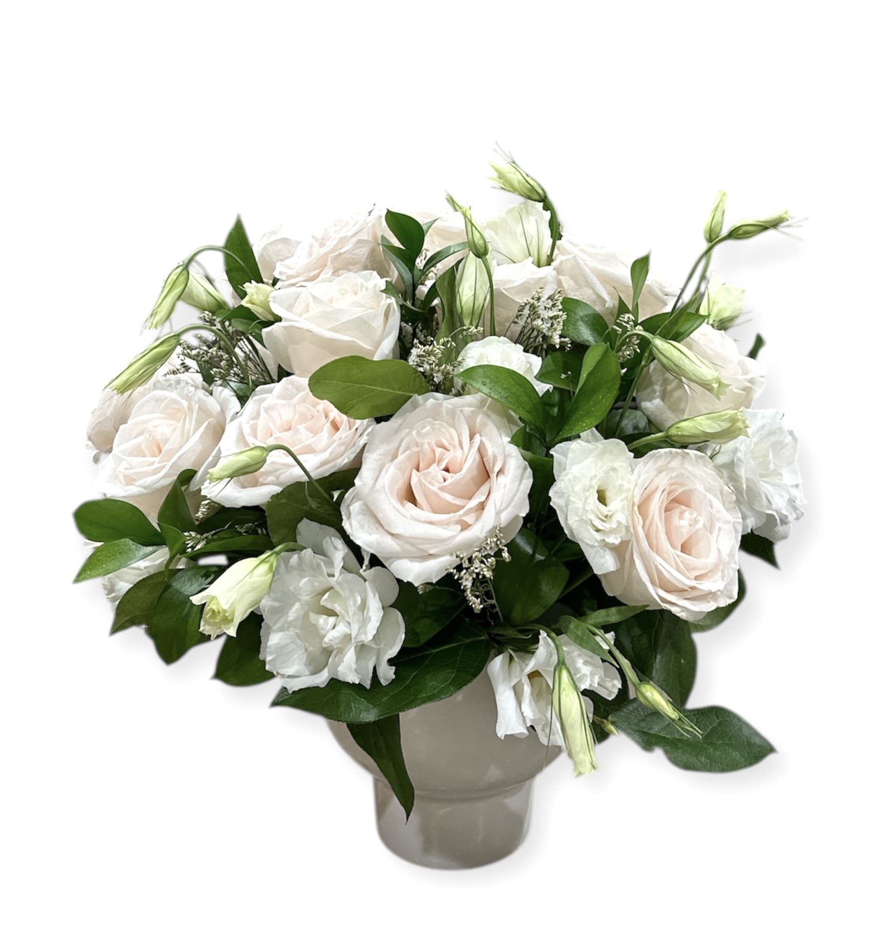 White and blush roses arranged in a gray vase