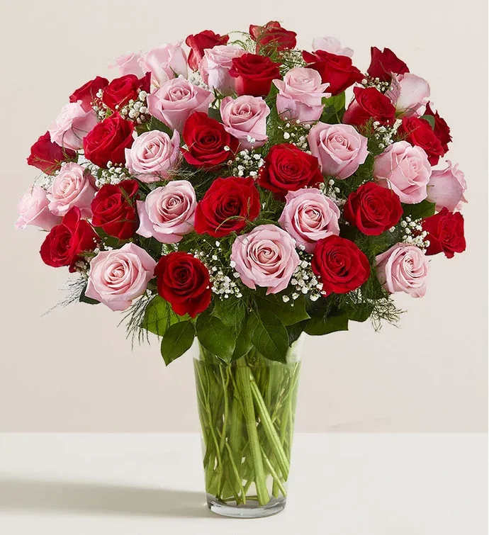 Bouquet of red and pink roses in a clear glass vase