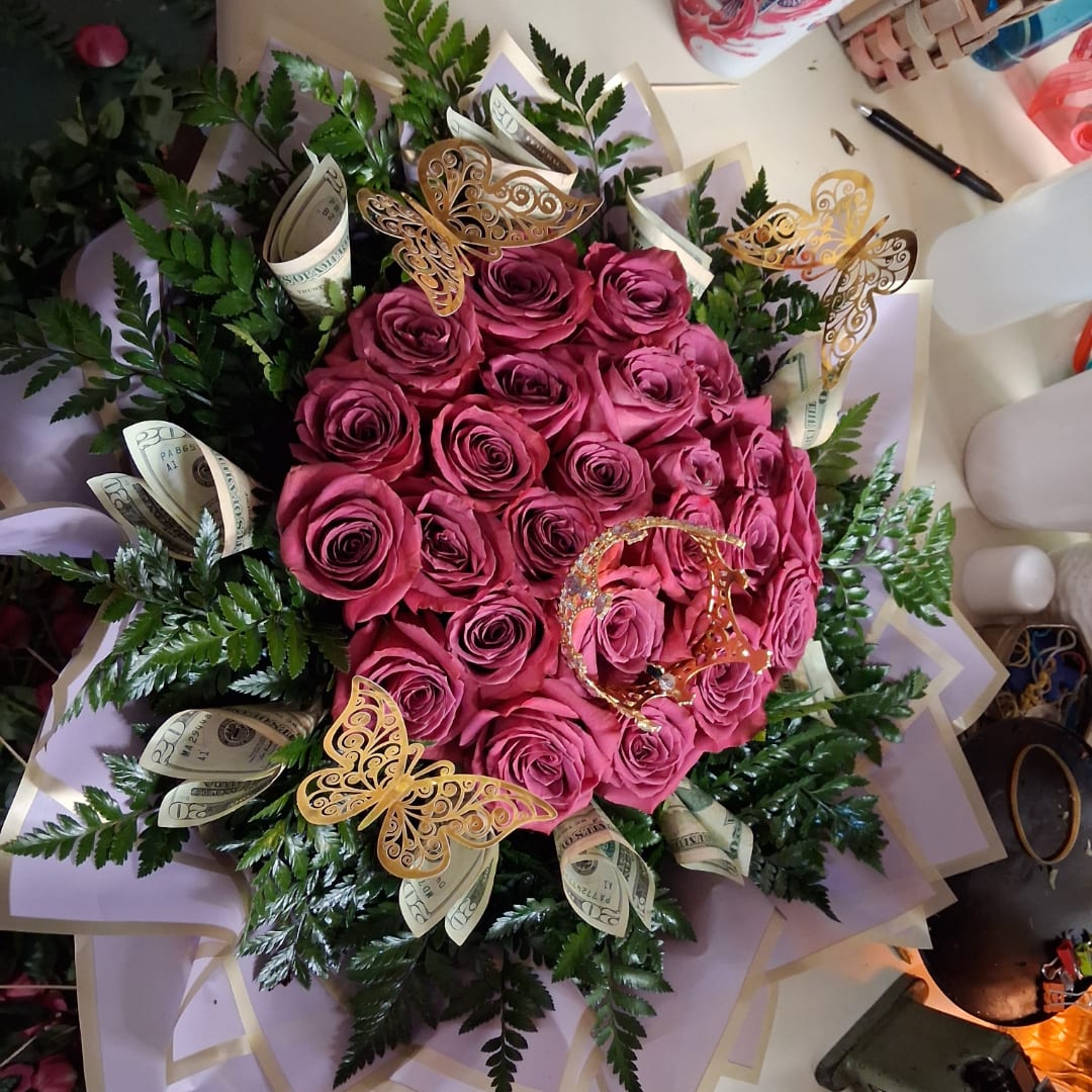 Pink rose bouquet with decorative butterflies and folded dollar bills
