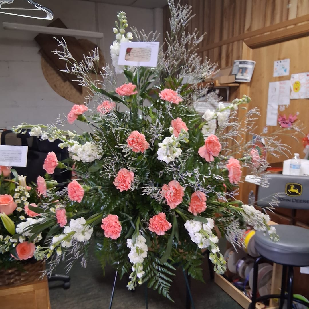 Large standing floral spray with pink carnations and white blooms