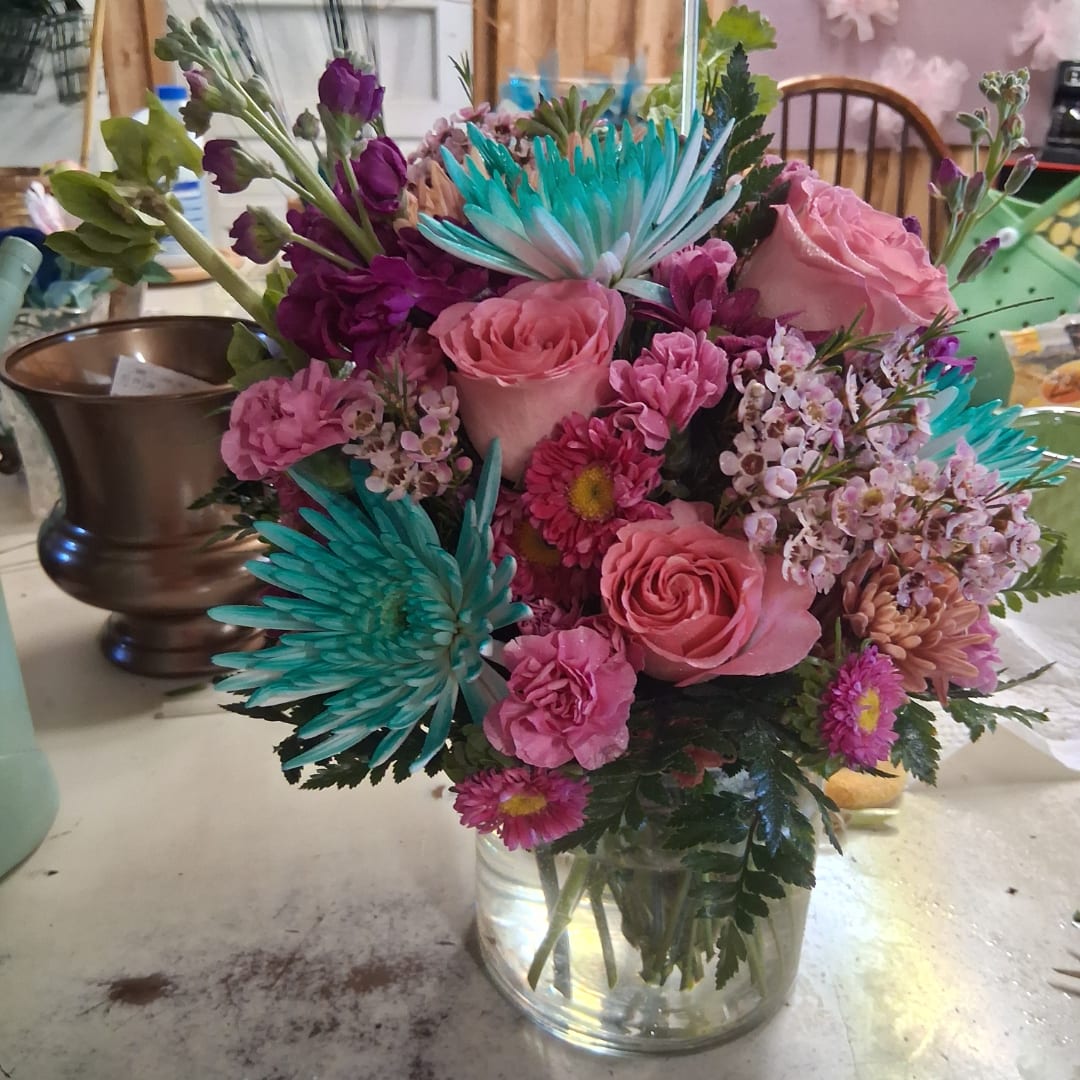 Pink and purple mixed bouquet in a glass vase