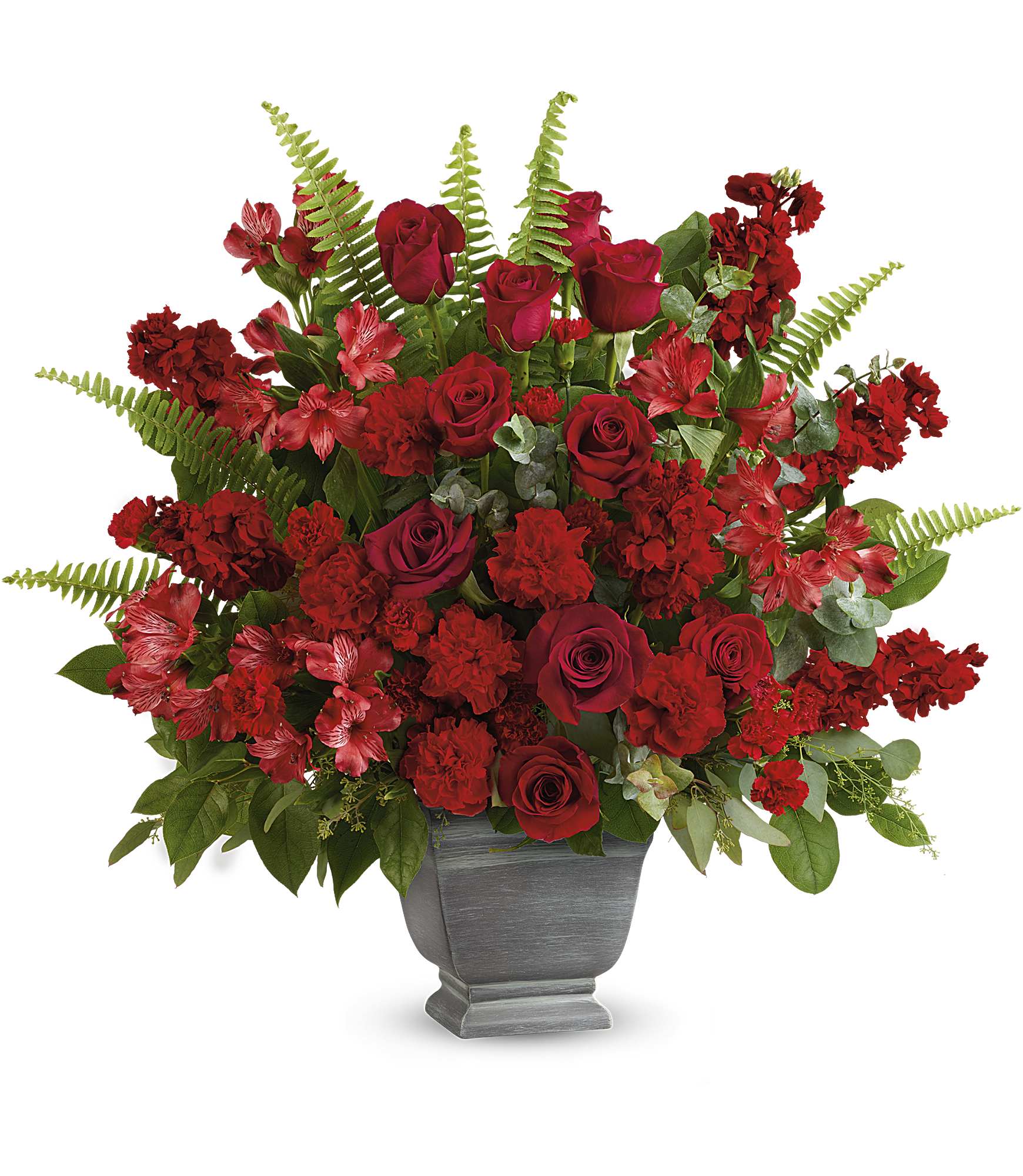 Red roses and carnations arranged in a gray urn vase